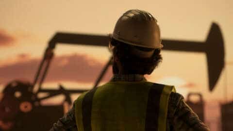 Oil engineer wearing a safety helmet and vest