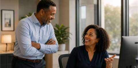 two coworkers talking in an office